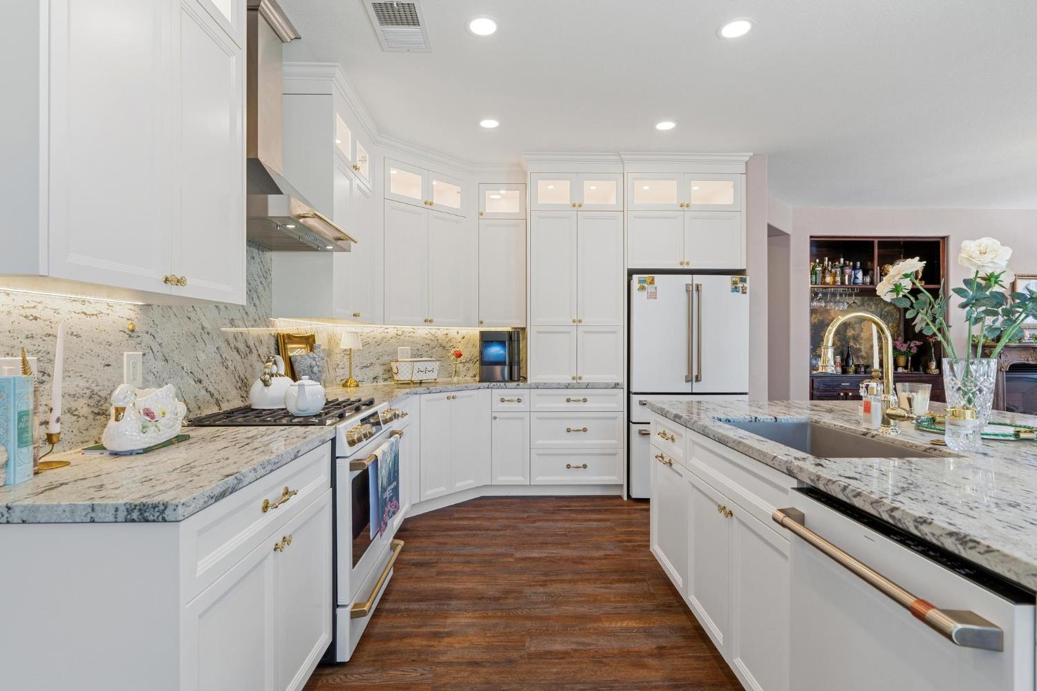 426 South Highland Avenue Ripon, CA 95366 - Photo 22 of 82 a large kitchen with granite countertop a stove and a sink
