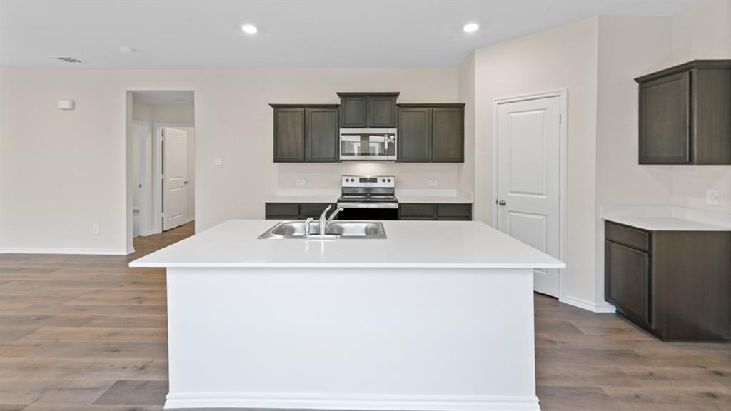 210 Pheasant Run Road Terrell, TX 75160 - Photo 2 of 28 a kitchen with a sink and a refrigerator