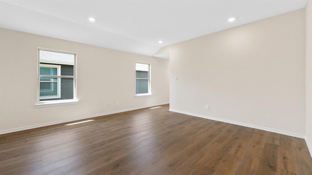 210 Pheasant Run Road Terrell, TX 75160 - Photo 10 of 28 a view of an empty room with wooden floor and a window