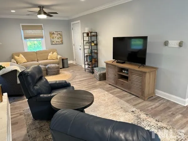 a living room with furniture and a flat screen tv