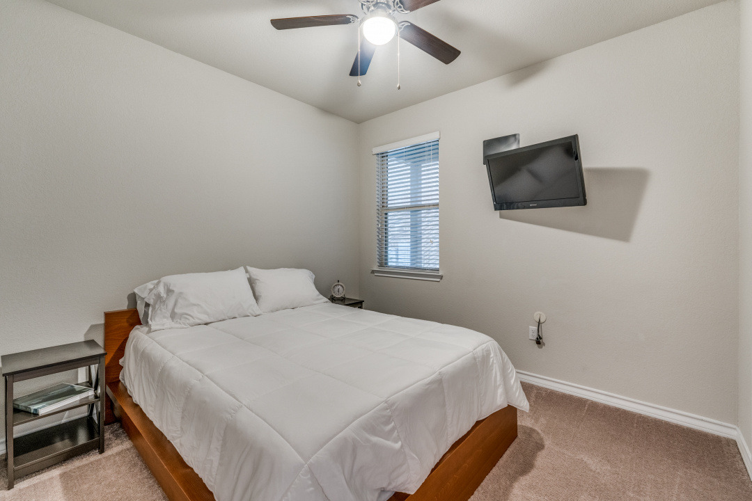 5921 Lehman Way Austin, TX 78747 - Photo 16 of 25 A well-lit bedroom offering practical comfort with a window for natural illumination.