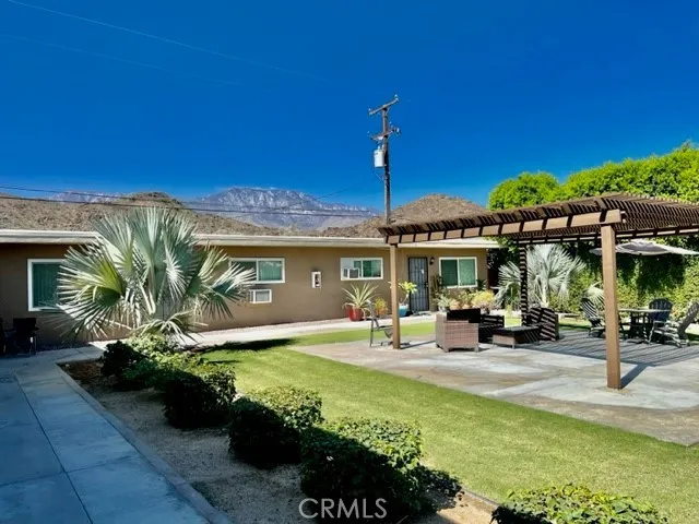 a view of a house with backyard outdoor seating area and furniture