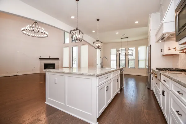 a kitchen with stainless steel appliances granite countertop a stove and a sink