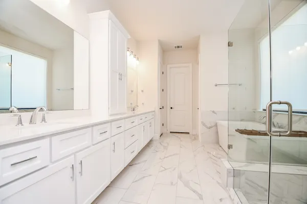 a spacious en suite bathroom with a double sink
