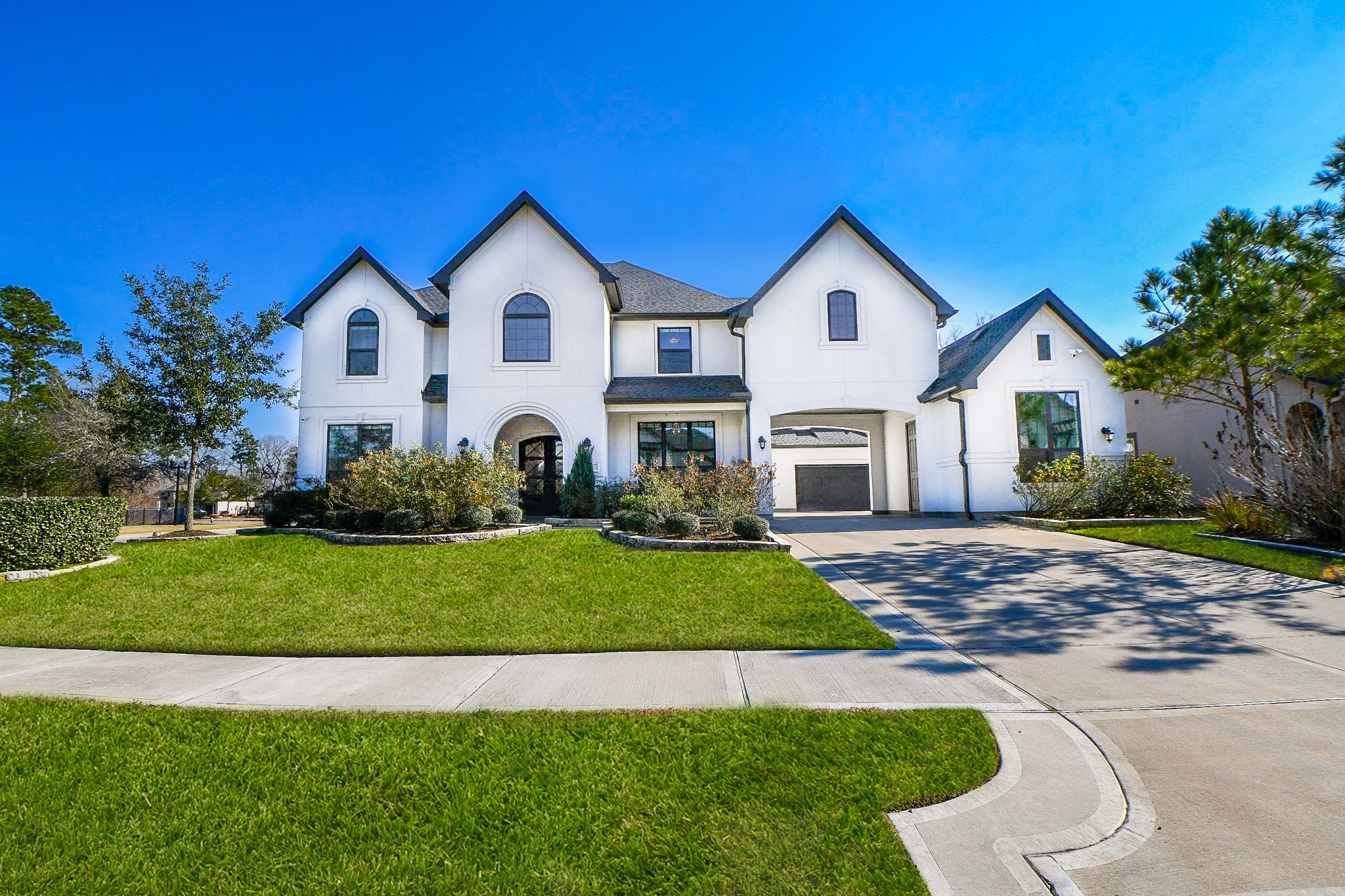 8526 Tombron Grove Road Magnolia, TX 77354 - Photo 2 of 50 a front view of a house with a yard and garage