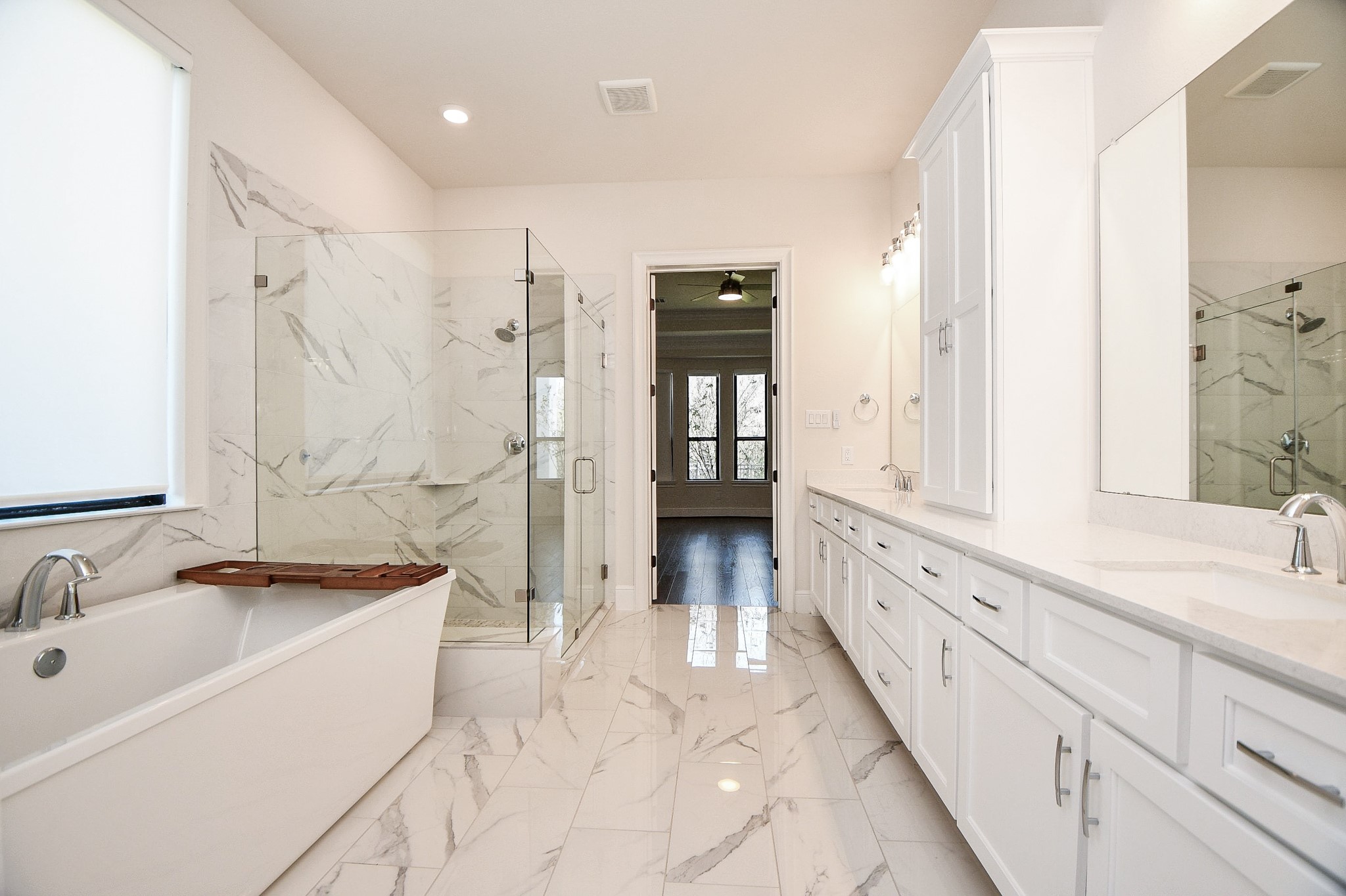 8526 Tombron Grove Road Magnolia, TX 77354 - Photo 22 of 50 a bathroom with a granite countertop sink mirror and a bathtub