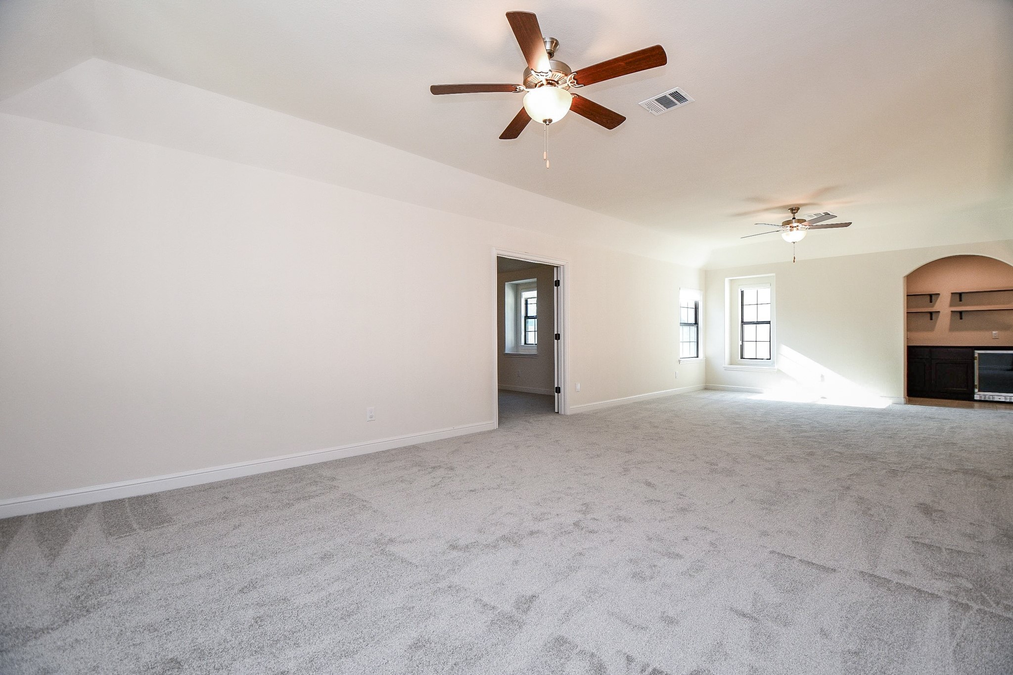 8526 Tombron Grove Road Magnolia, TX 77354 - Photo 24 of 50 an empty room with chandelier fan and windows