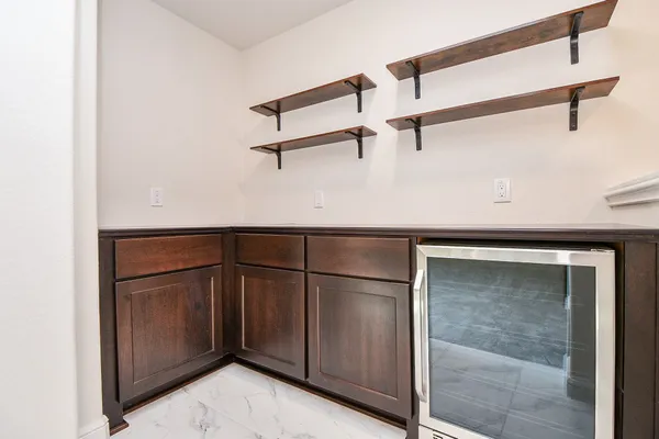 a kitchen with a refrigerator and cabinets
