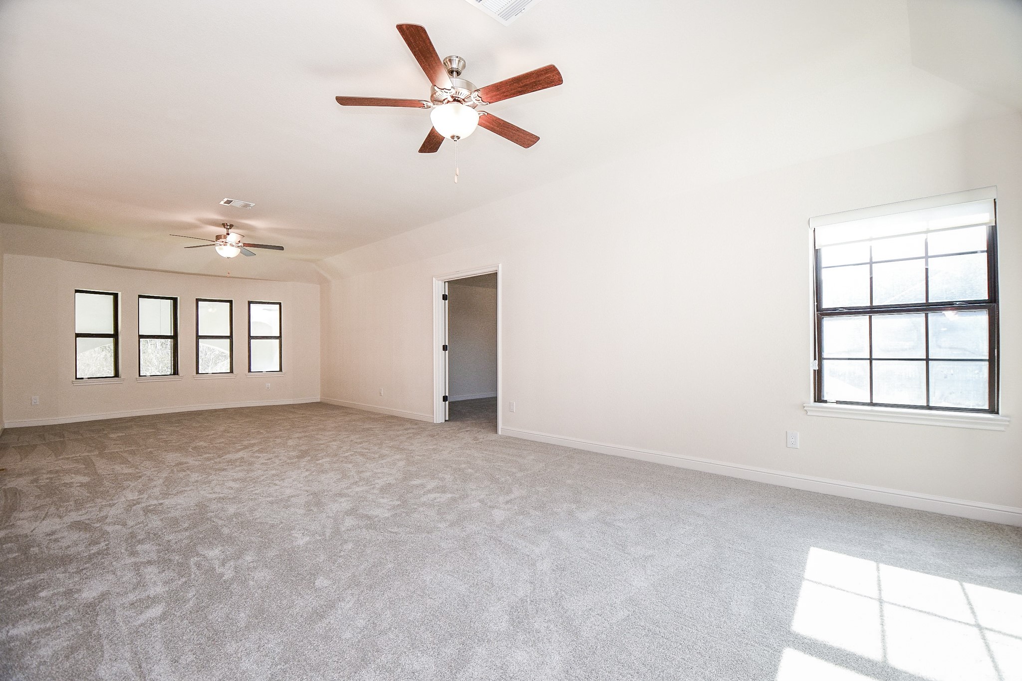8526 Tombron Grove Road Magnolia, TX 77354 - Photo 28 of 50 an empty room with windows and ceiling fan