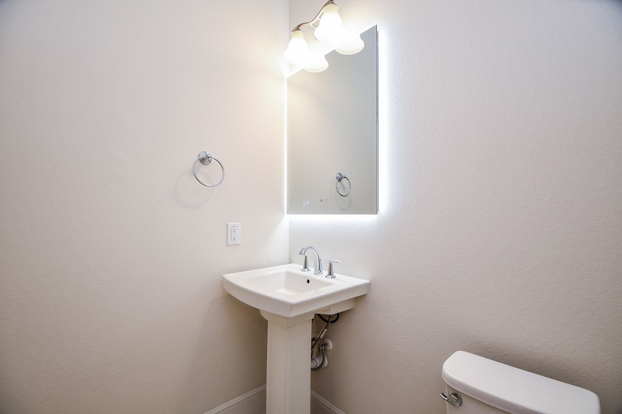 8526 Tombron Grove Road Magnolia, TX 77354 - Photo 40 of 50 a bathroom with a sink a toilet and mirror