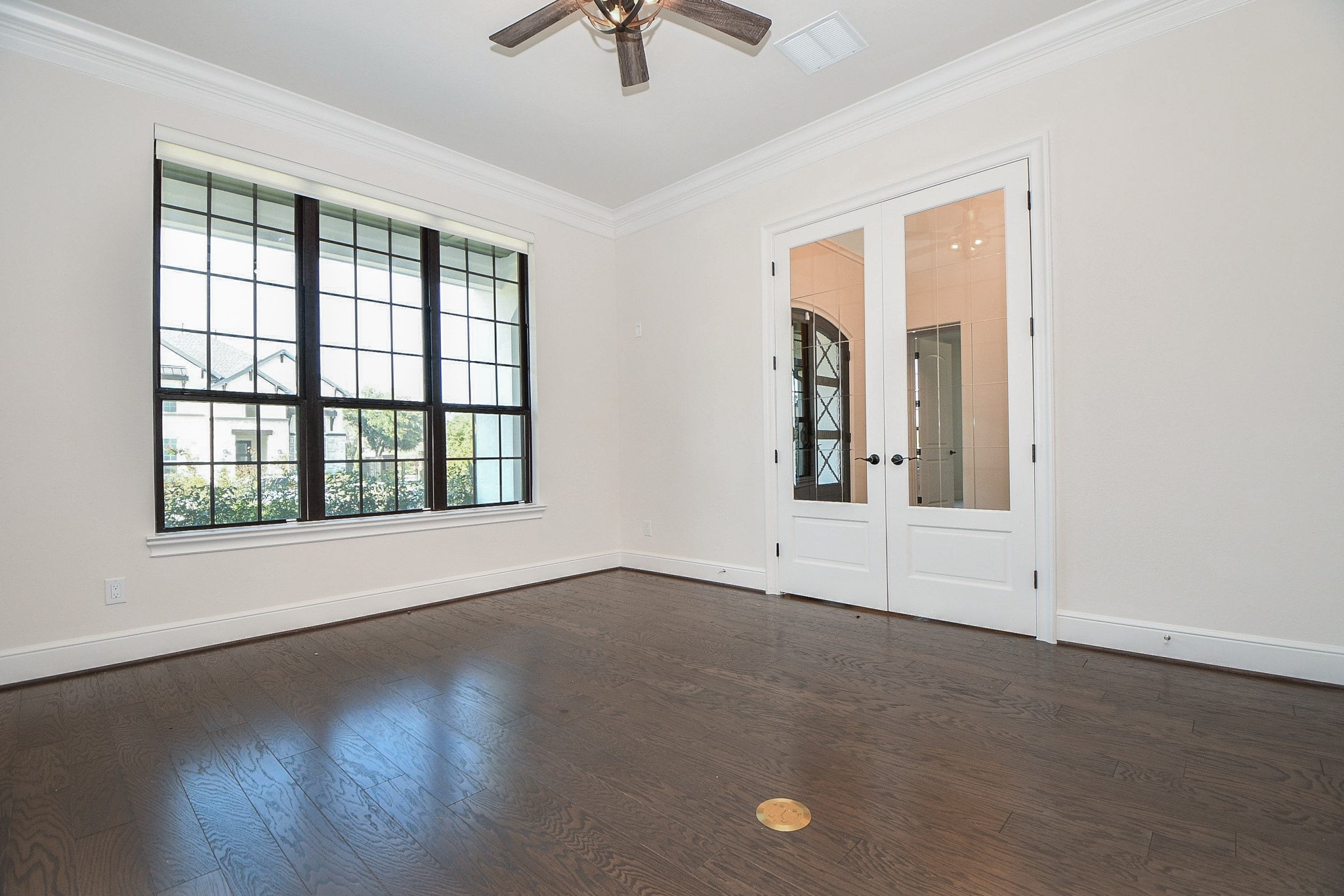 8526 Tombron Grove Road Magnolia, TX 77354 - Photo 8 of 50 an empty room with wooden floor chandelier fan and windows