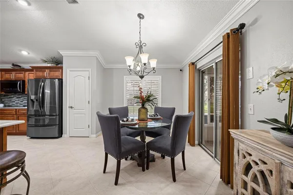 a view of a dining room with furniture and a chandelier