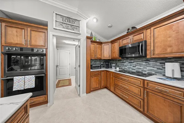 a kitchen with stainless steel appliances granite countertop a refrigerator and a stove top oven