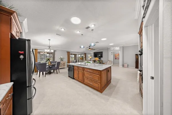 a kitchen with stainless steel appliances granite countertop a refrigerator and a sink