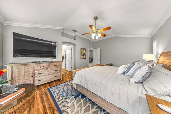 a bedroom with a bed and flat screen tv