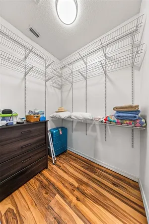 a spacious bedroom with a large window and a bed