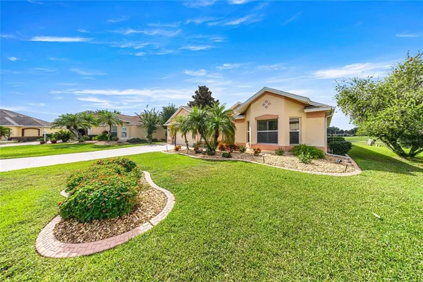 an aerial view of a house with garden space and street view