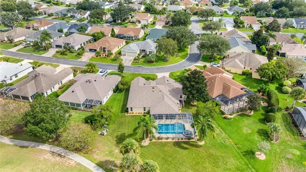 an aerial view of a house with a garden and lake view