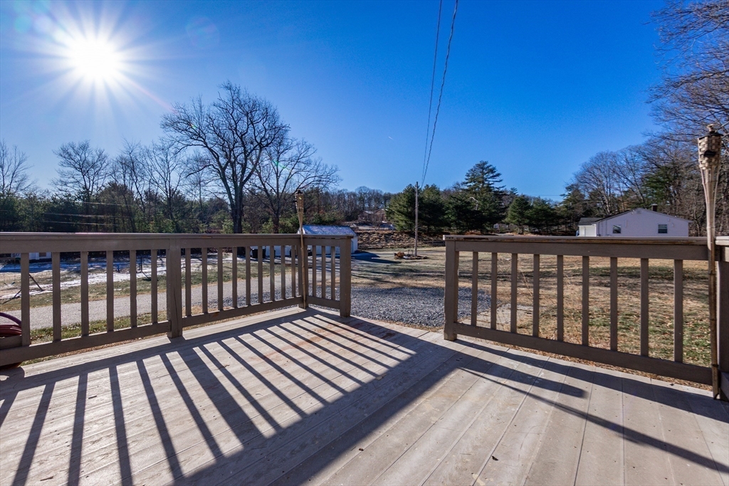 65 Depot Road, Unit A Oxford, MA 01540 - Photo 12 of 17 a view of balcony with wooden floor and fence
