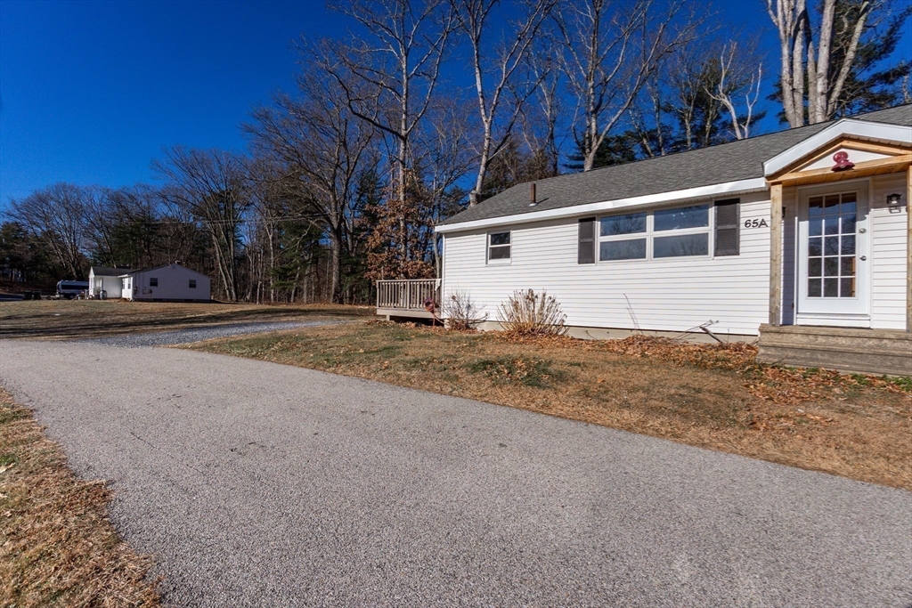65 Depot Road, Unit A Oxford, MA 01540 - Photo 16 of 17 a house with trees in front of it
