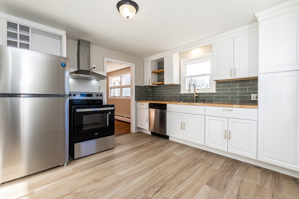 65 Depot Road, Unit A Oxford, MA 01540 - Photo 2 of 17 a kitchen with stainless steel appliances a refrigerator sink and cabinets
