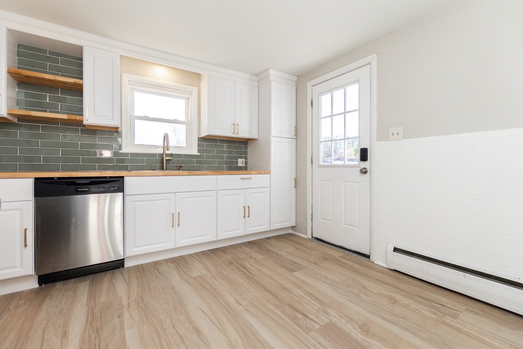 65 Depot Road, Unit A Oxford, MA 01540 - Photo 3 of 17 a view of a kitchen with wooden floor and electronic appliances