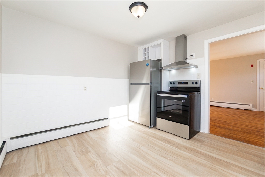65 Depot Road, Unit A Oxford, MA 01540 - Photo 4 of 17 a kitchen with granite countertop a refrigerator and a stove top oven