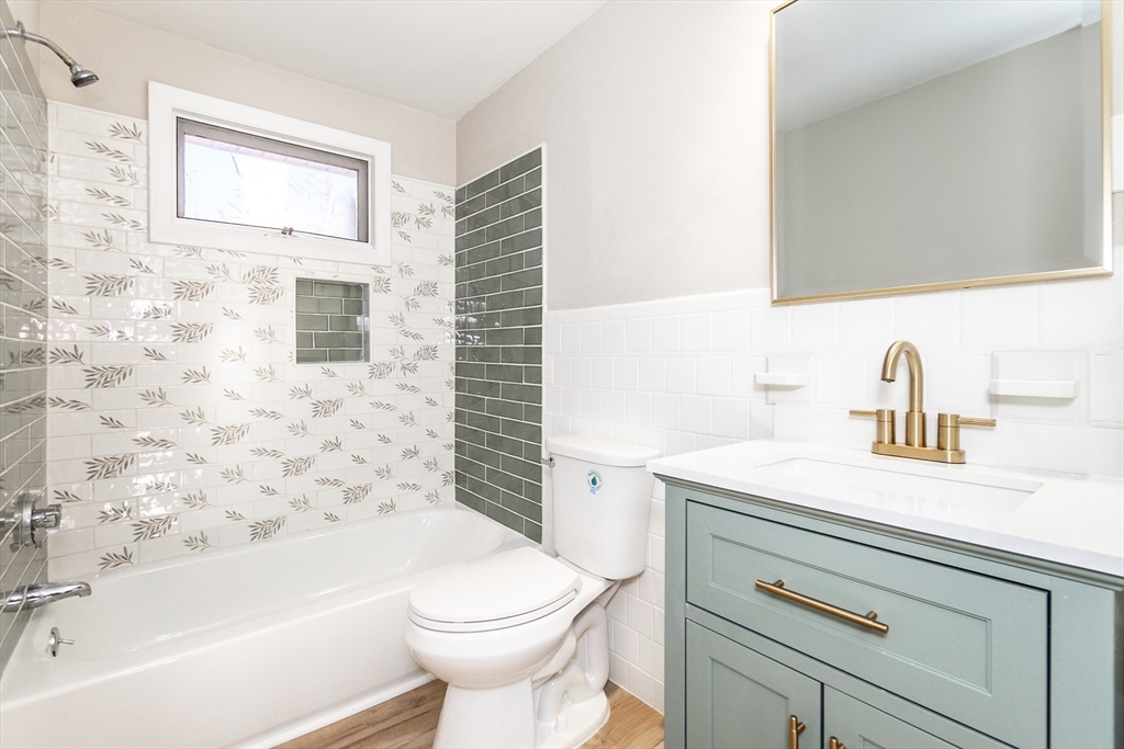 65 Depot Road, Unit A Oxford, MA 01540 - Photo 7 of 17 a bathroom with a sink a toilet and shower