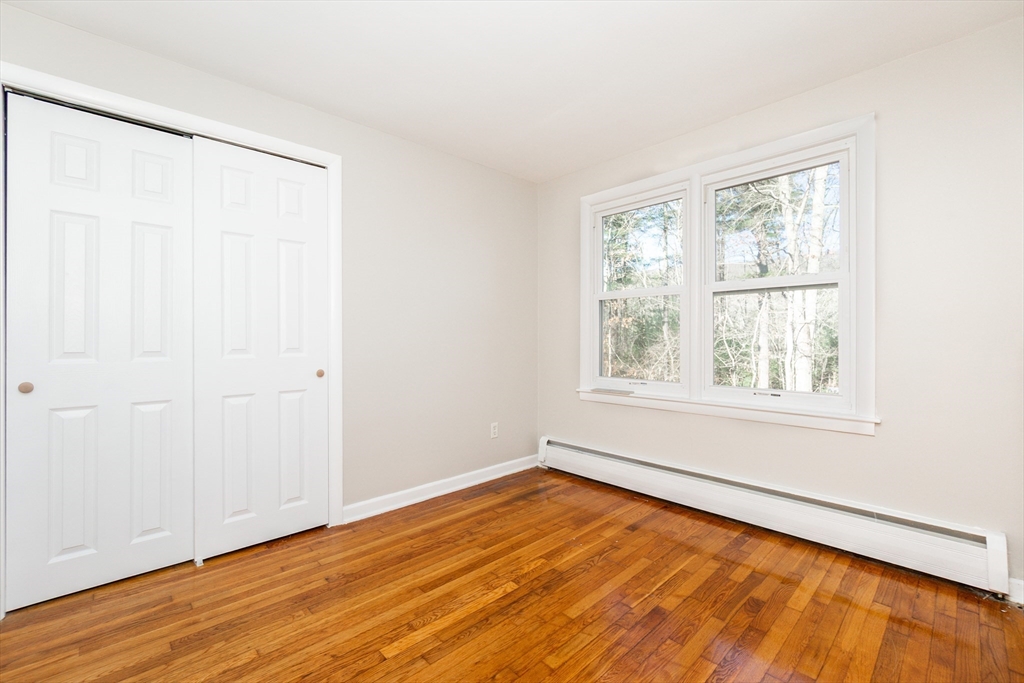 65 Depot Road, Unit A Oxford, MA 01540 - Photo 8 of 17 an empty room with wooden floor and windows