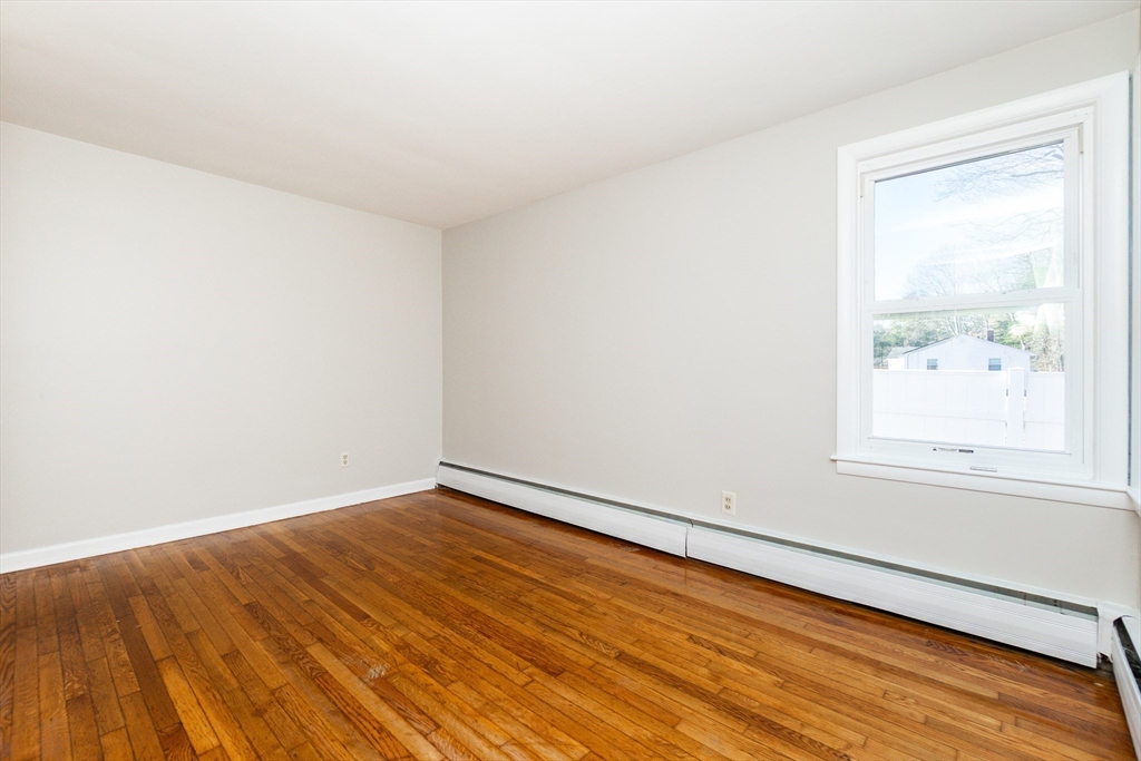 65 Depot Road, Unit A Oxford, MA 01540 - Photo 9 of 17 an empty room with wooden floor and windows