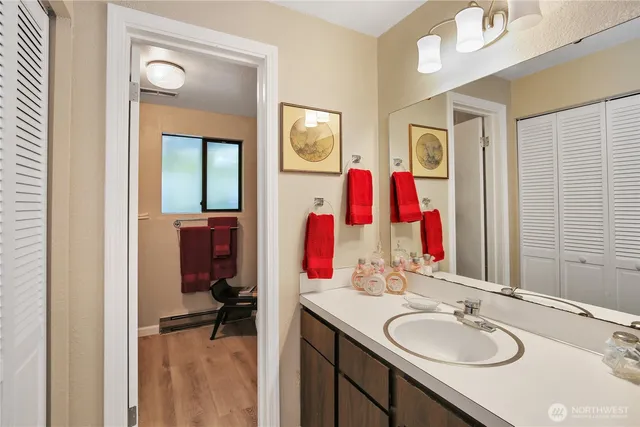 a bathroom with a toilet mirror and sink