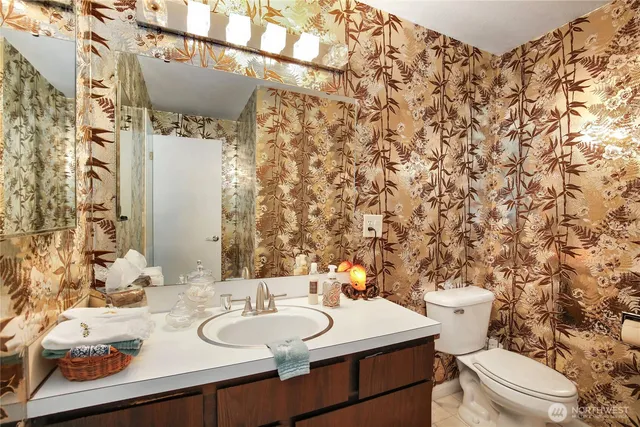 a view of staircase with lots of frames and a rug