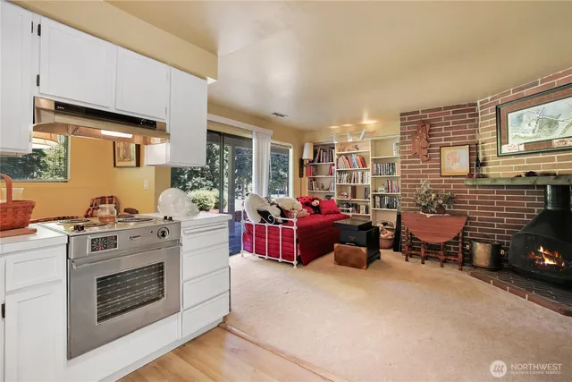 a living room with furniture gym equipment and large windows