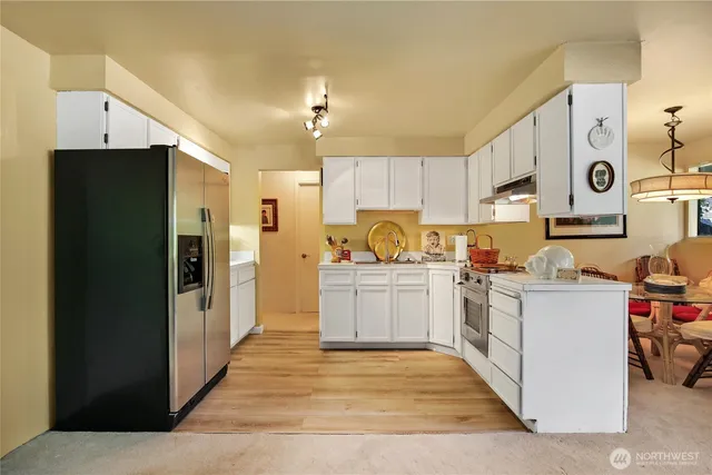 a view of a livingroom with furniture and a refrigerator