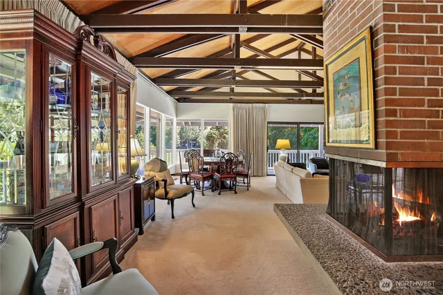 a view of a dining room with furniture a chandelier and wooden floor