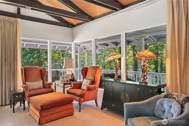 a living room with furniture a lamp and a large window