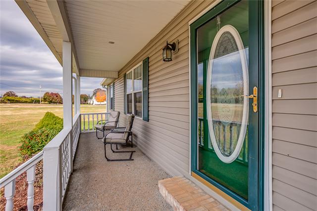 There's nothing more peaceful than enjoying this rocking chair front porch three seasons during the year.