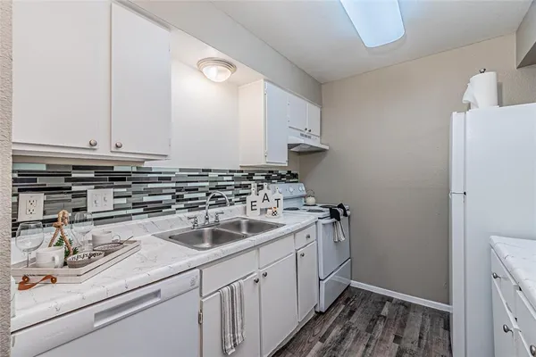 a view of a kitchen with a sink and a potted plant