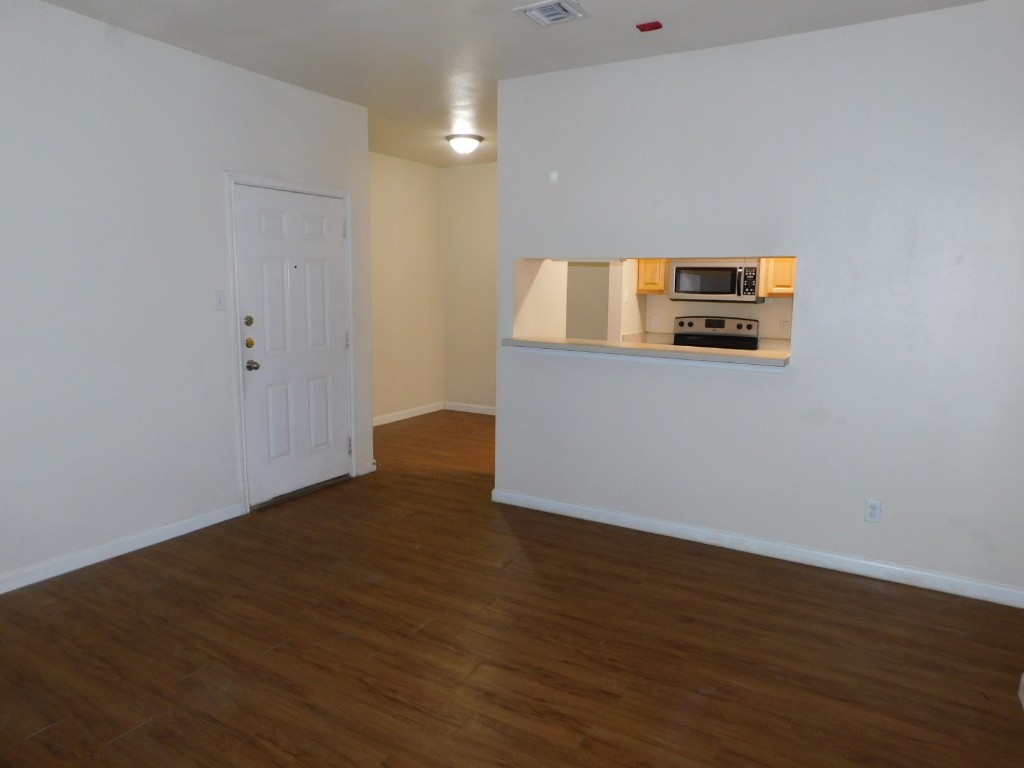 12166 Metric Boulevard, Unit 153 Austin, TX 78758 - Photo 4 of 8 a view of empty room with wooden floor