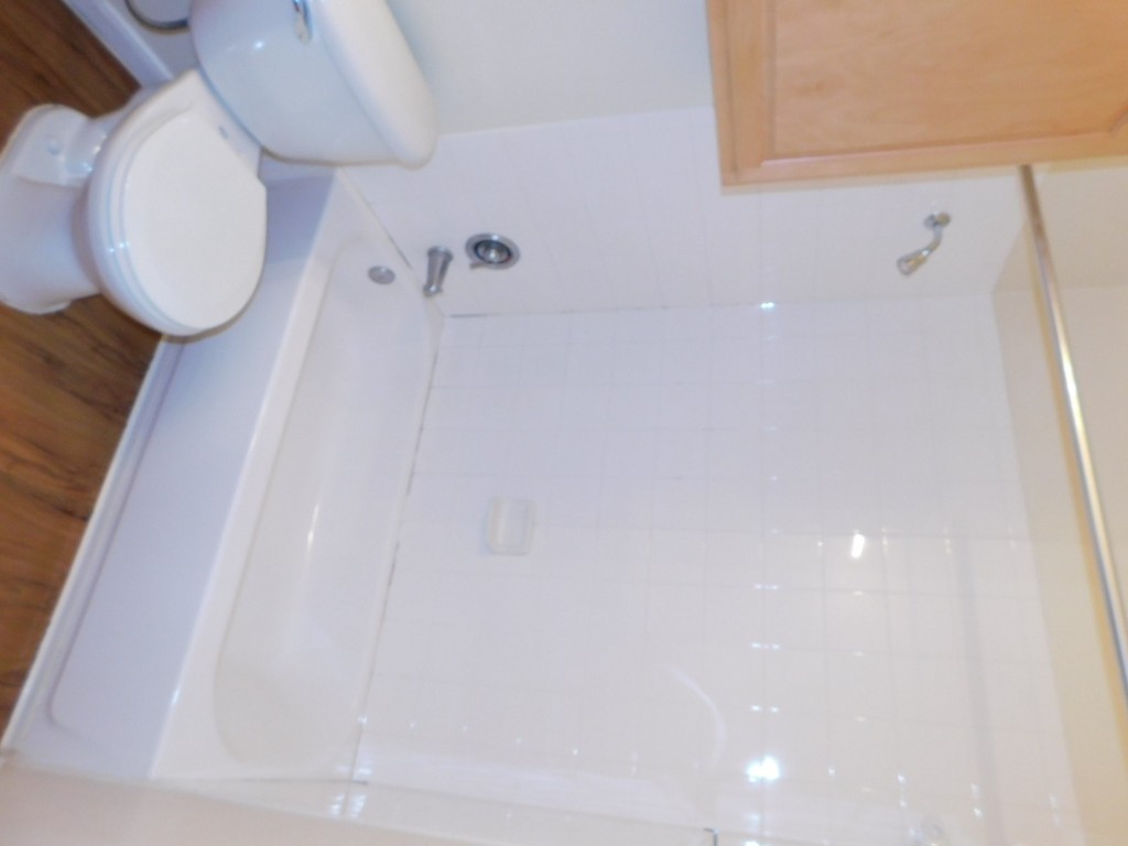 12166 Metric Boulevard, Unit 153 Austin, TX 78758 - Photo 6 of 8 a bathroom with a toilet and a bathtub