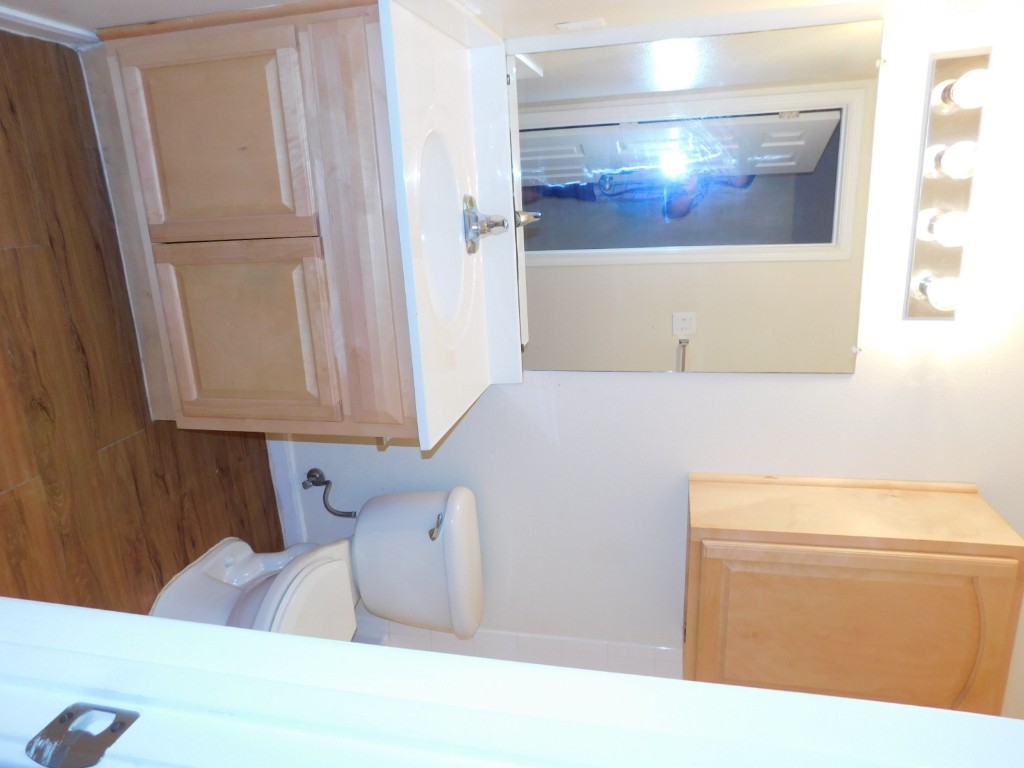 12166 Metric Boulevard, Unit 153 Austin, TX 78758 - Photo 7 of 8 a bathroom with a sink and a mirror