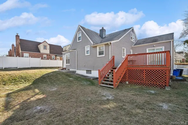 a view of a wooden bench sitting in front of a house