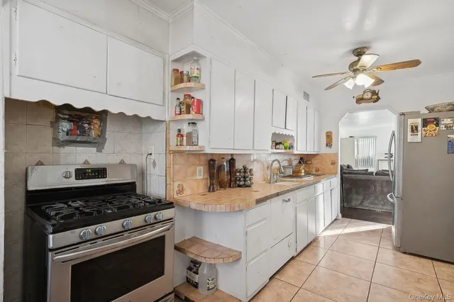 a kitchen with kitchen island a stove cabinets and counter space
