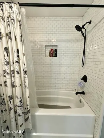 a bathroom with a bathtub and shower