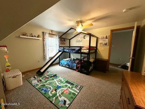 a bedroom with a bed and a ceiling fan