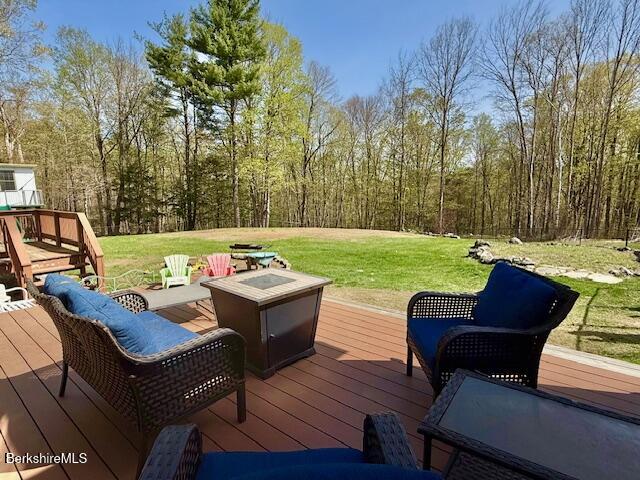 279 Goss Hill Road Chester, MA 01050 - Photo 18 of 24 a view of a patio with couches chairs and a fire pit