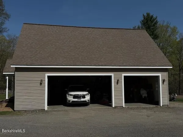 a view of a house with a yard and garage