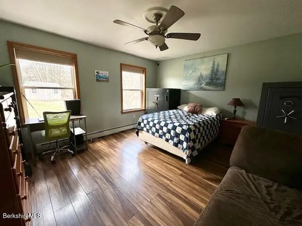 a bedroom with a bed dresser and a window