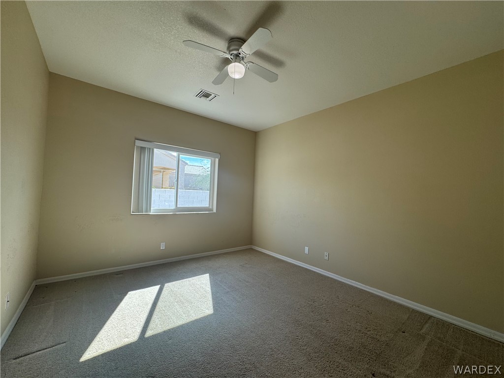 3323 North Ridge Avenue Bullhead City, AZ 86429 - Photo 15 of 24 The property features a room with vaulted ceilings and a ceiling fan with an integrated light fixture