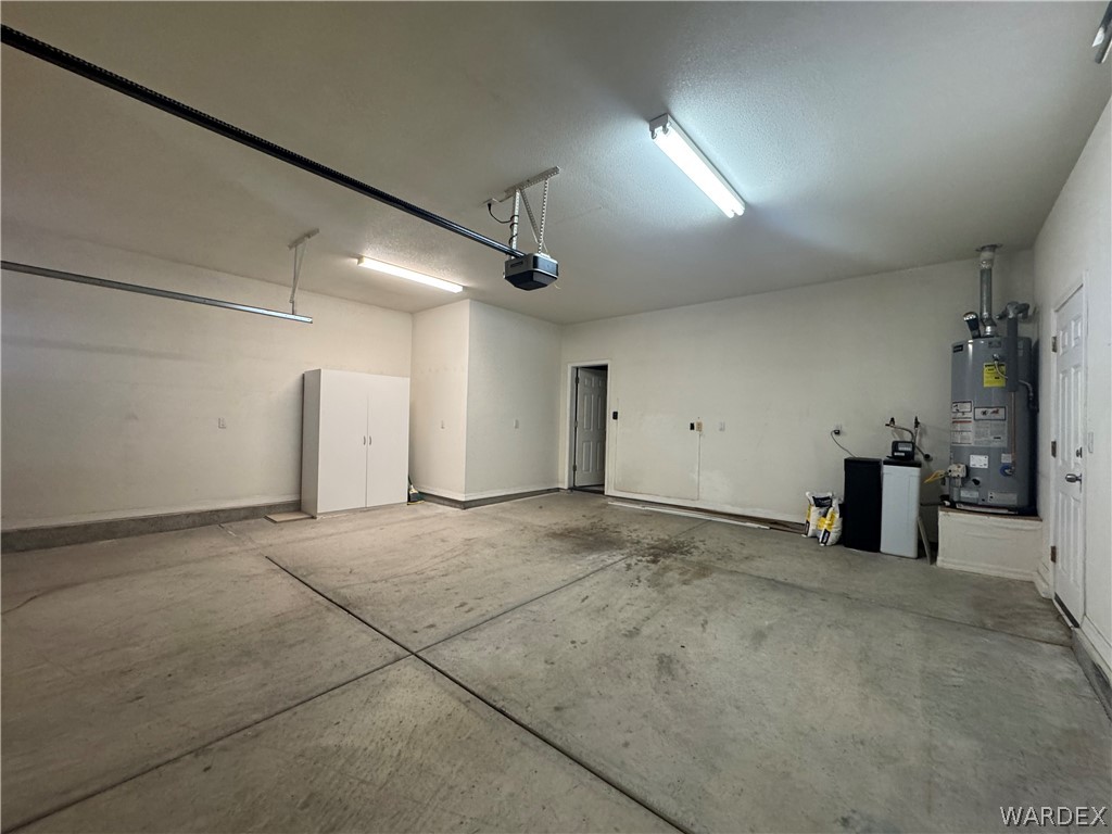 3323 North Ridge Avenue Bullhead City, AZ 86429 - Photo 24 of 24 Spacious garage with concrete flooring, overhead lighting, and white storage cabinetry